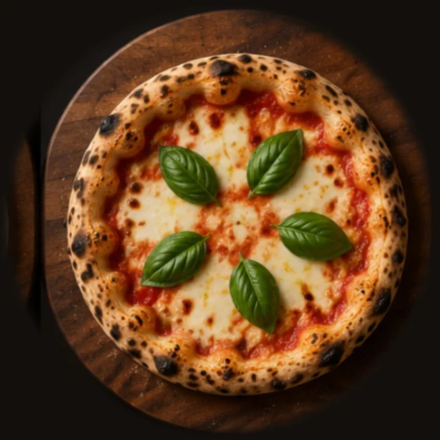 The finished margherita with a leopard-spotted crust and basil