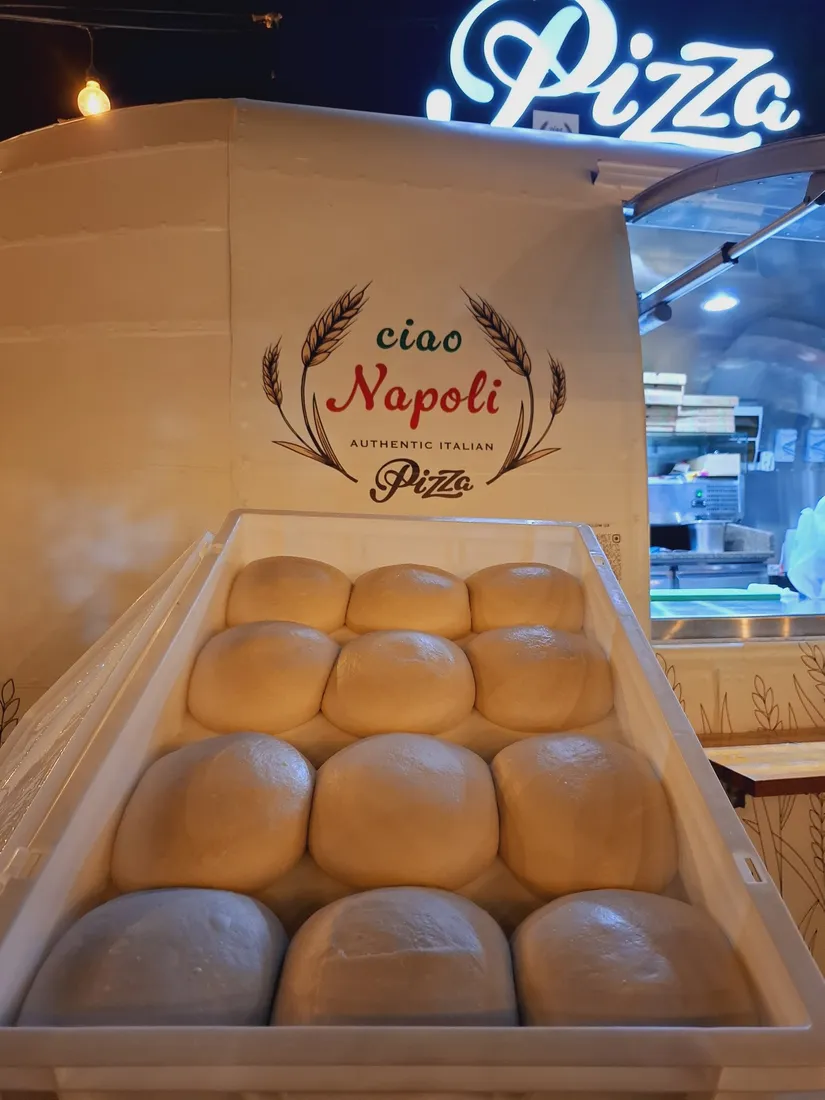 Dough balls resting in a tray in front of the truck