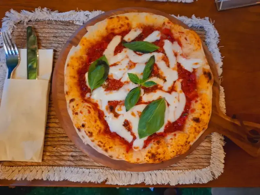 Margherita with basil on a wooden board