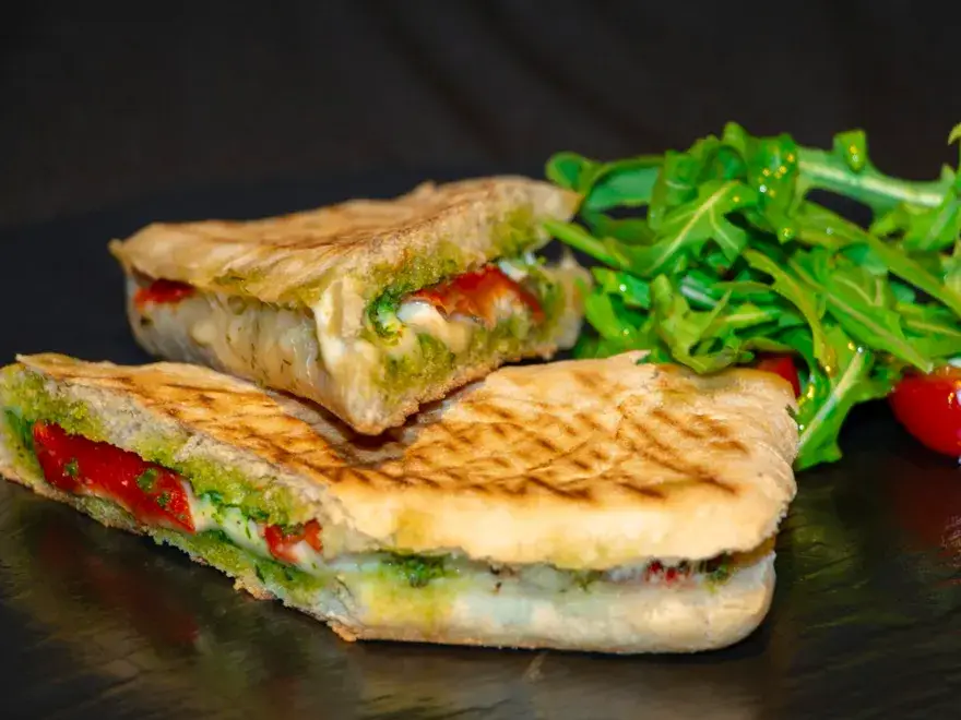 Grilled panini with mozzarella, pesto and tomato