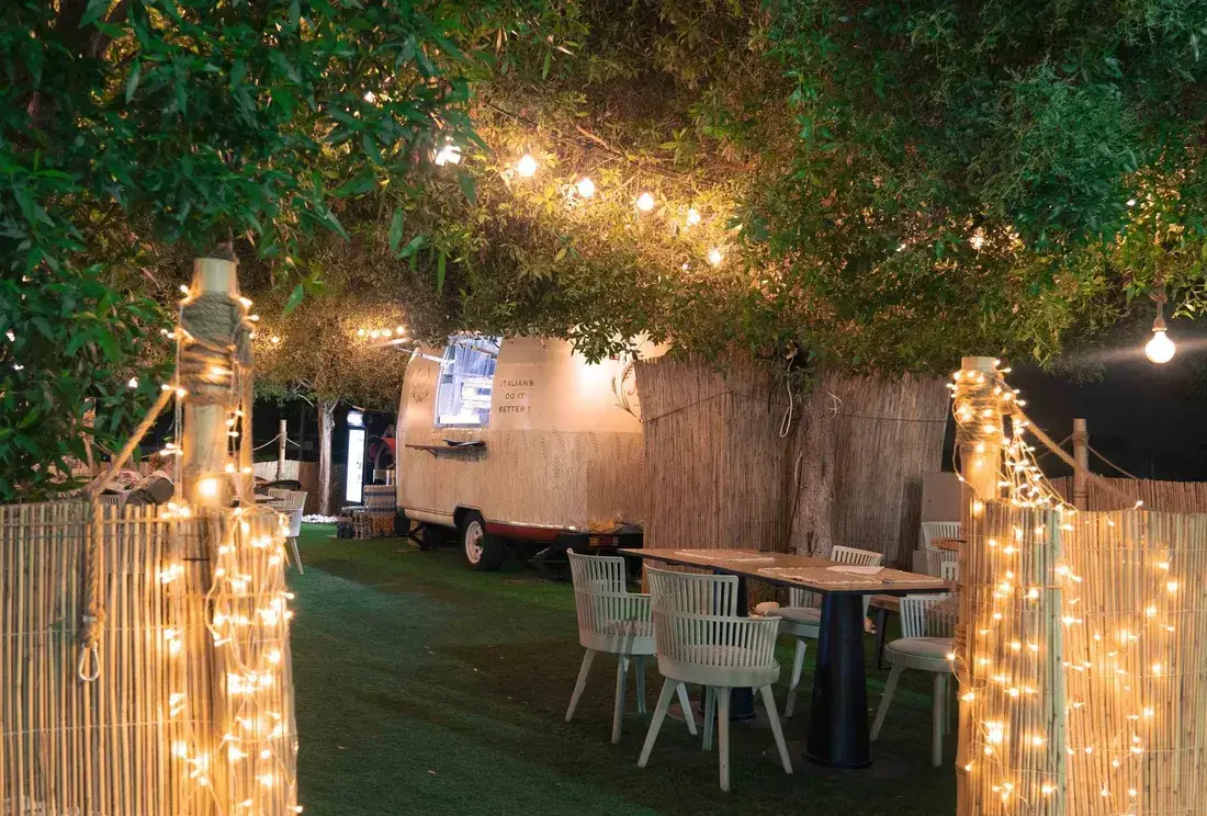The terrace under string lights with the truck behind